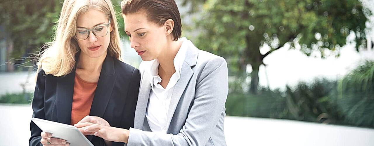 businesswoman-corporate-colleagues-talking-P3PSNFM